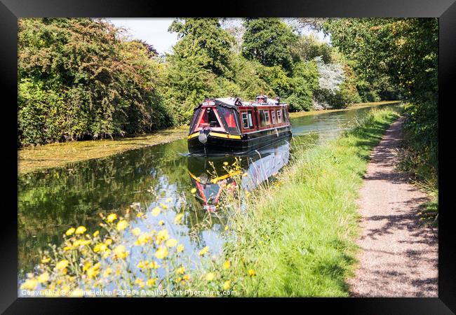 A narrowboat makes its way along the Grand Union c Framed Print by Kevin Hellon