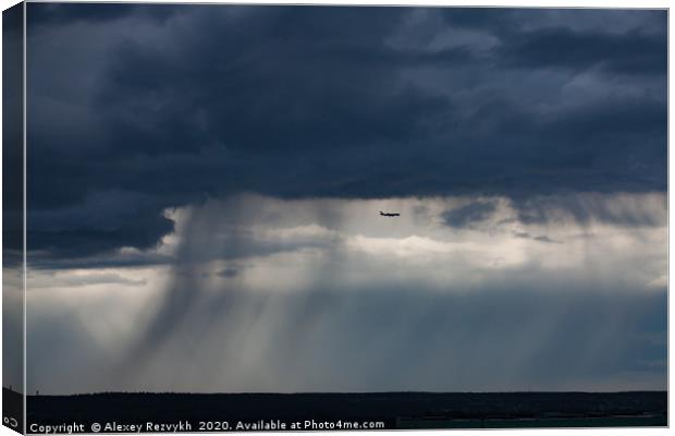 Air jet and the storm cloud. Moscow, Russia. Canvas Print by Alexey Rezvykh