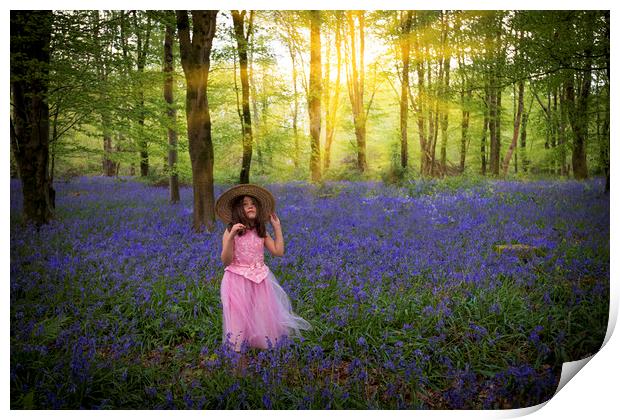 Small girl walks through bluebell woods in pink dress Print by Alan Hill