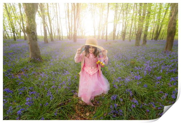 Small girl walks through bluebell woods in pink dress Print by Alan Hill