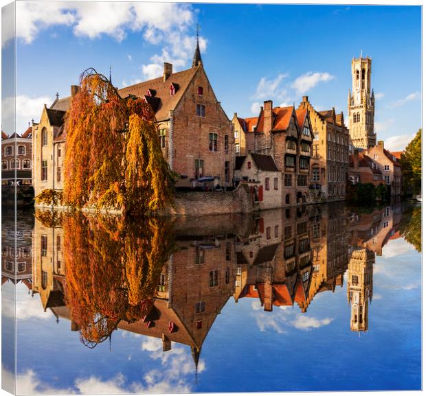 Canals and Buildings of Bruges in Belgium in autumn Canvas Print by Alan Hill
