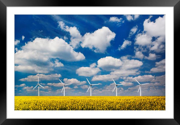 Wind turbines in a field under blue skies Framed Mounted Print by Alan Hill