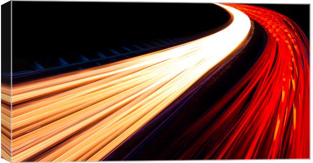 Light trails caused by multiple car headlights and tail lights Canvas Print by Alan Hill