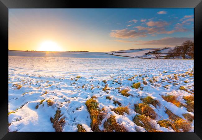 Snowy field at sunset under blue skies Framed Print by Alan Hill