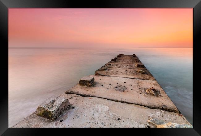 Stone jetty and calm seas Framed Print by Alan Hill