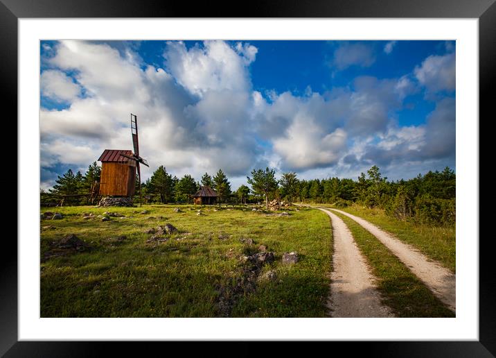 Wooden windmill and a rural road.  Framed Mounted Print by Alexey Rezvykh