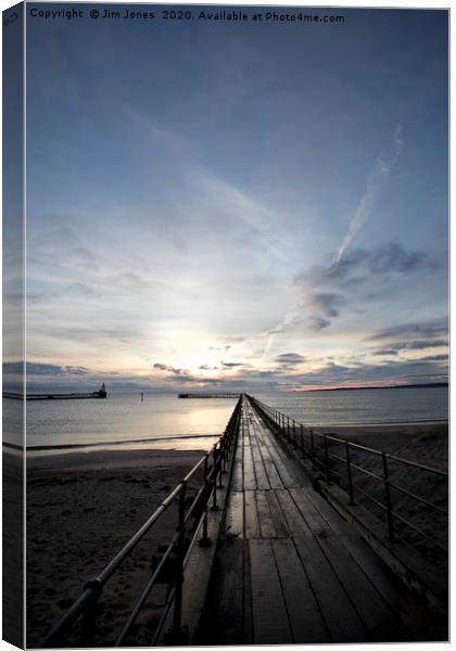 Sunrise at the end of the Old Wooden Pier Canvas Print by Jim Jones