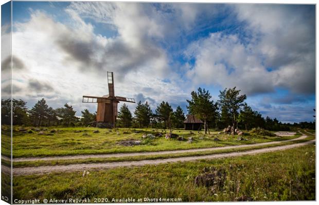 Wooden windmill and rural road. Canvas Print by Alexey Rezvykh