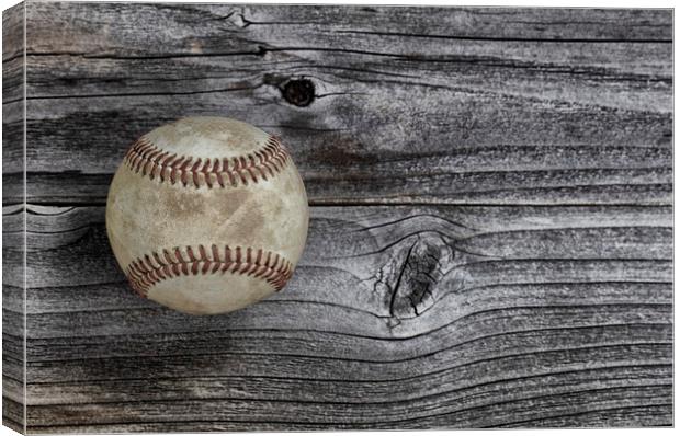 Single used baseball on vintage wooden background. Canvas Print by Thomas Baker