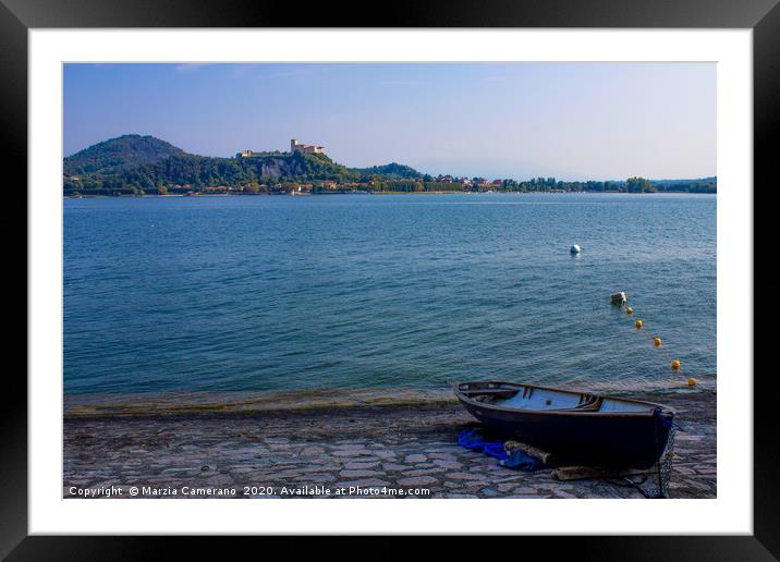Boat moored on lake Maggiore against sky Framed Mounted Print by Marzia Camerano