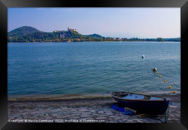 Boat moored on lake Maggiore against sky Framed Print by Marzia Camerano