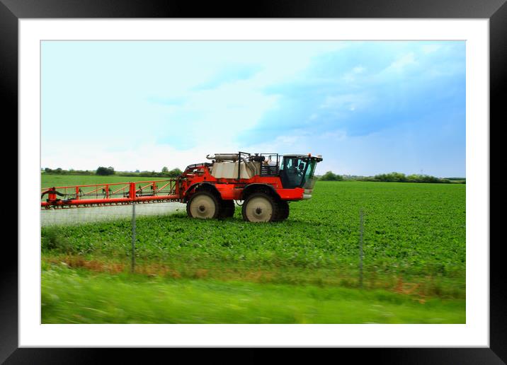 Tractor spraying wheat field with sprayer during s Framed Mounted Print by M. J. Photography