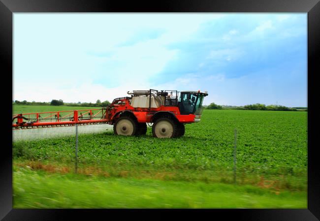 Tractor spraying wheat field with sprayer during s Framed Print by M. J. Photography