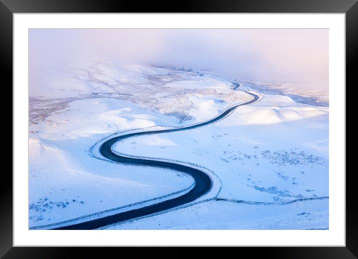 Bendy road through the snow Framed Mounted Print by Andrew Kearton