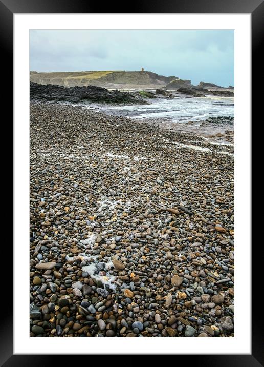 Wet pebble beach Framed Mounted Print by Dave Bell