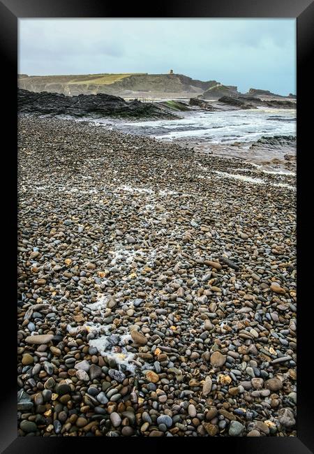 Wet pebble beach Framed Print by Dave Bell