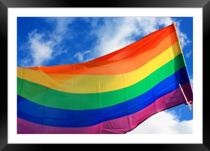 Rainbow flag (LGBT movement) on the sky background Framed Mounted Print by M. J. Photography