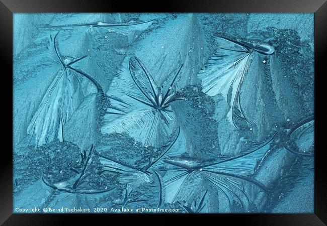 Frost pattern of ice flowers on window Framed Print by Bernd Tschakert