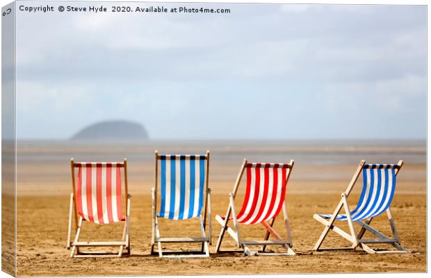 Colourful wooden deck chairs on a beach Canvas Print by Steve Hyde
