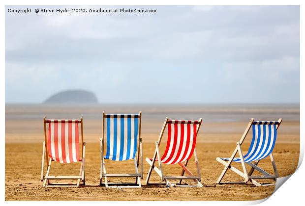 Colourful wooden deck chairs on a beach Print by Steve Hyde