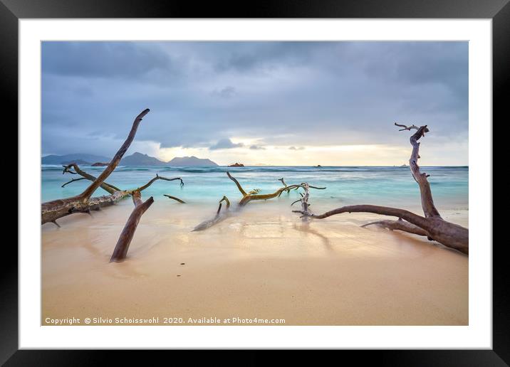 Clouds over a natural sandy beach on La Digue Framed Mounted Print by Silvio Schoisswohl