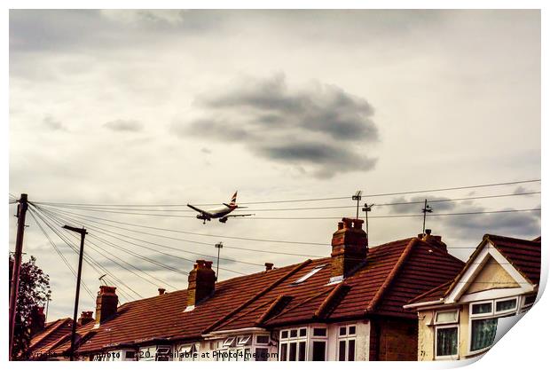 Passenger plane flying over the roofs of residenti Print by Q77 photo
