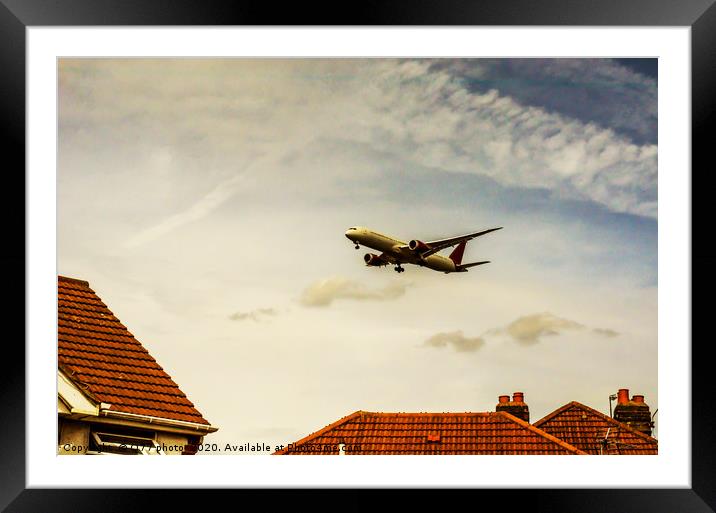 Passenger plane flying over the roofs of residenti Framed Mounted Print by Q77 photo