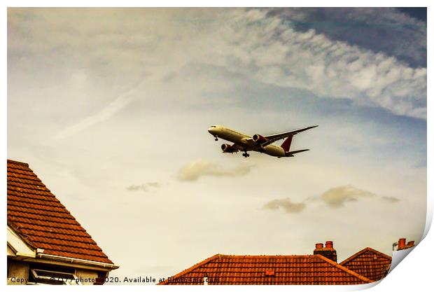Passenger plane flying over the roofs of residenti Print by Q77 photo