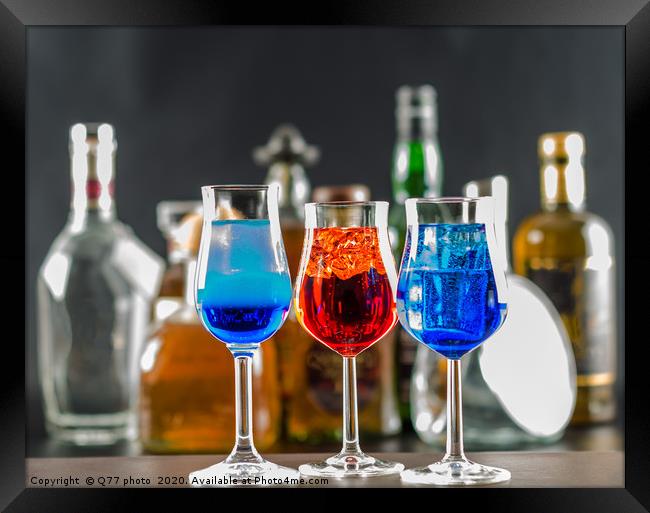 Colorful drink on the background of bottles in ori Framed Print by Q77 photo