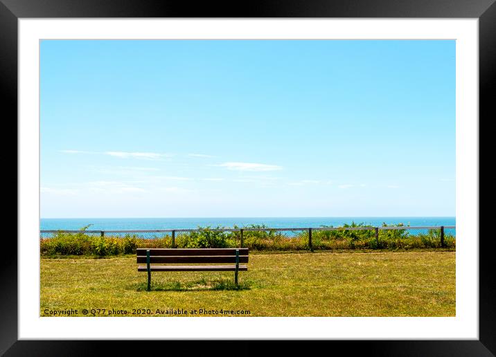 Empty bench on a hill on the ocean shore, green lu Framed Mounted Print by Q77 photo