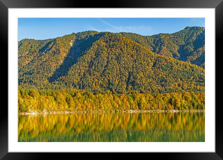 Autumn colored trees reflecting in a lake  Framed Mounted Print by Christian Pauschert