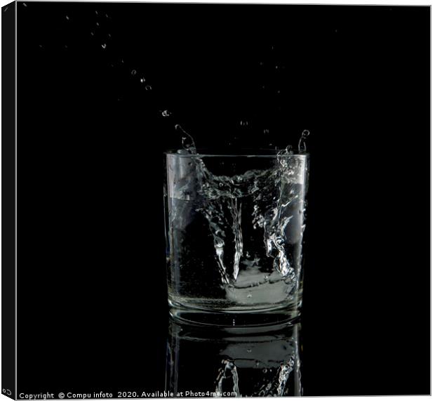 splash from a falling ice cube in glass of water Canvas Print by Chris Willemsen