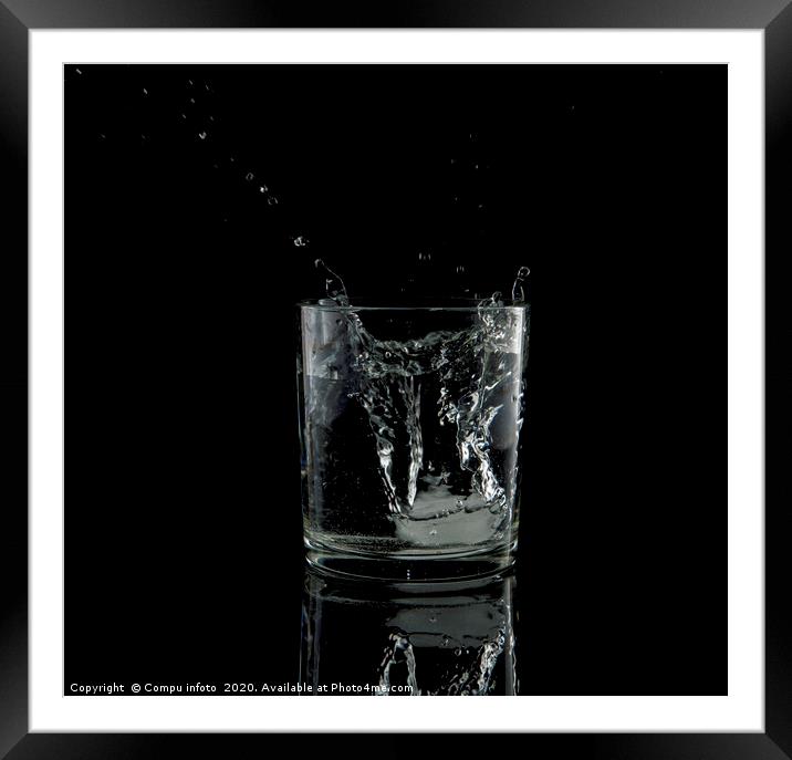 splash from a falling ice cube in glass of water Framed Mounted Print by Chris Willemsen