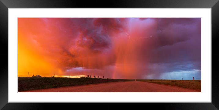 Sunset thunderstorm with rainbow and lightning. Framed Mounted Print by John Finney