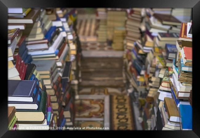 Stack of old books, selective focus. Framed Print by RUBEN RAMOS