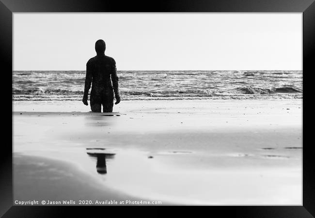 Iron Man looking out to sea Framed Print by Jason Wells