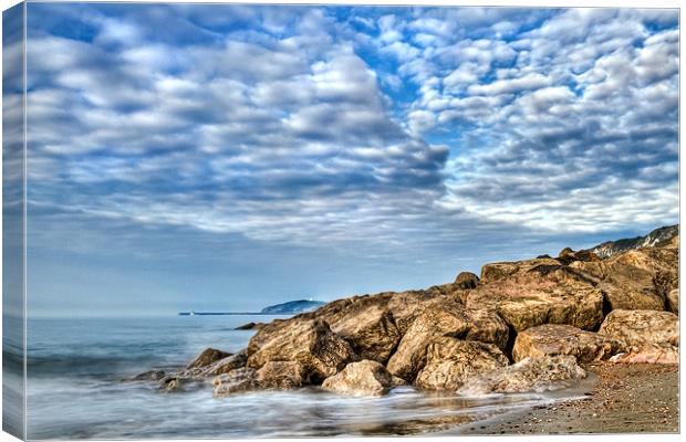 Beach and Cotton Clouds Canvas Print by Alice Gosling