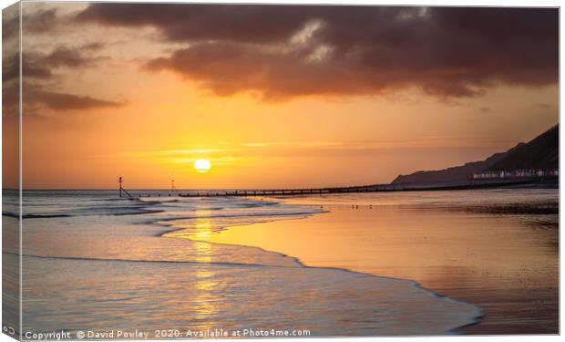 Sunrise over Cromer beach Canvas Print by David Powley
