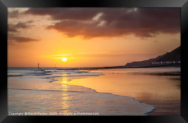 Sunrise over Cromer beach Framed Print by David Powley