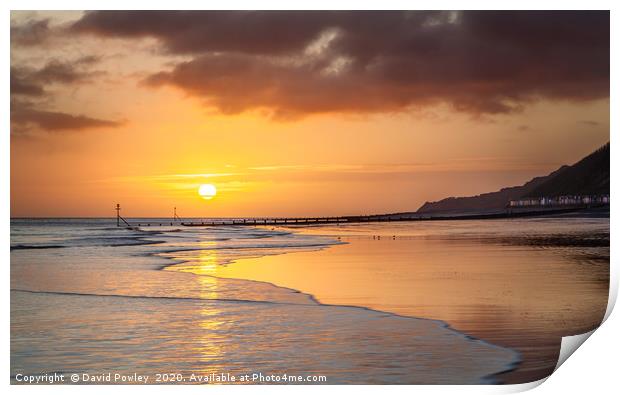 Sunrise over Cromer beach Print by David Powley
