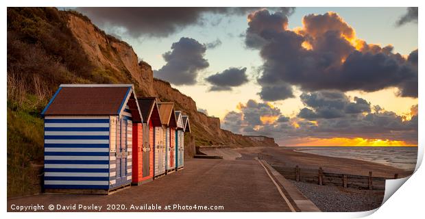 Cromer beach huts at sunset Print by David Powley