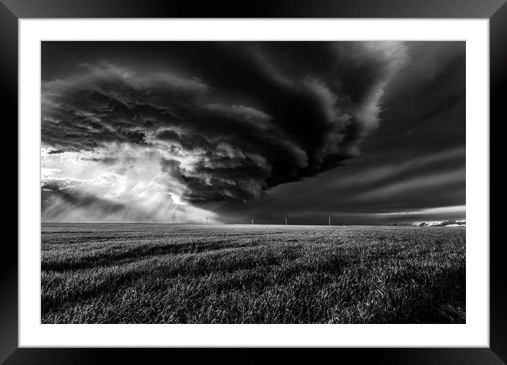 Sunlight through a storm. black and white Framed Mounted Print by John Finney
