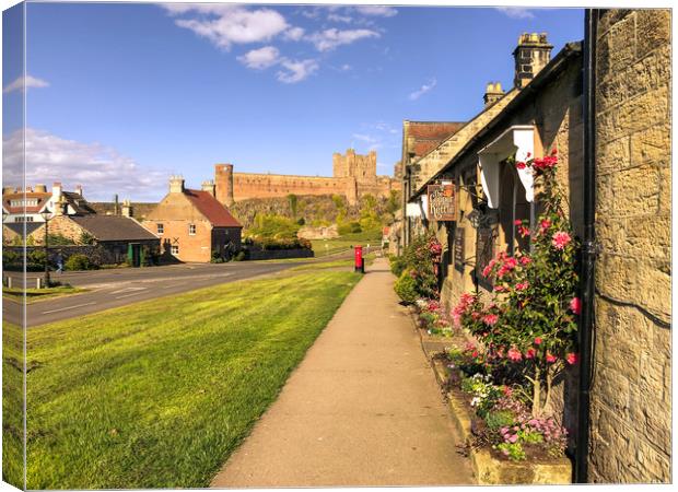 Bamburgh cottages and imposing castle Canvas Print by Naylor's Photography
