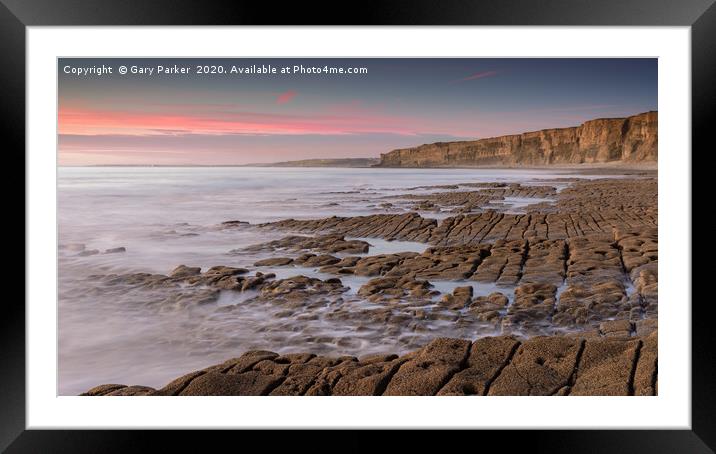 The ocean, washing over a rocky shore, at sunset Framed Mounted Print by Gary Parker