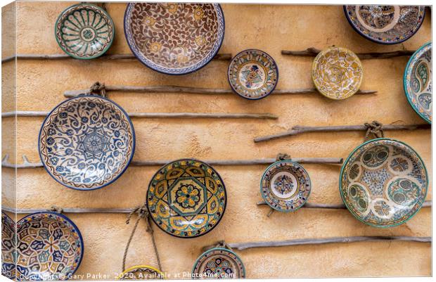 Traditional, patterned ceramic plates, on a wall Canvas Print by Gary Parker