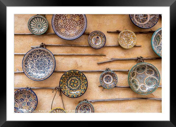 Traditional, patterned ceramic plates, on a wall Framed Mounted Print by Gary Parker