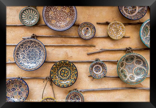 Traditional, patterned ceramic plates, on a wall Framed Print by Gary Parker
