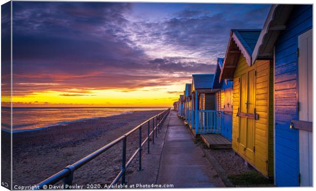 Sunrise over Cromer Beach Huts Canvas Print by David Powley