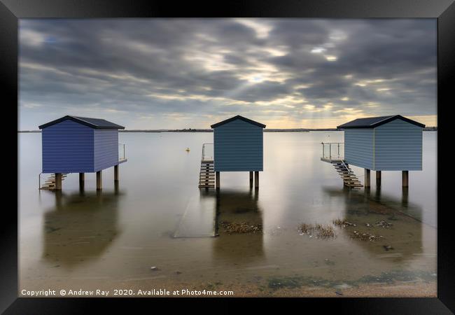 Shafts of light over Osea Beach Huts Framed Print by Andrew Ray