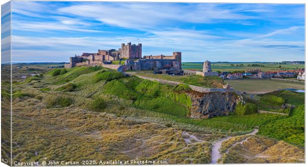 Majestic Bamburgh Castle at Sunrise Canvas Print by John Carson